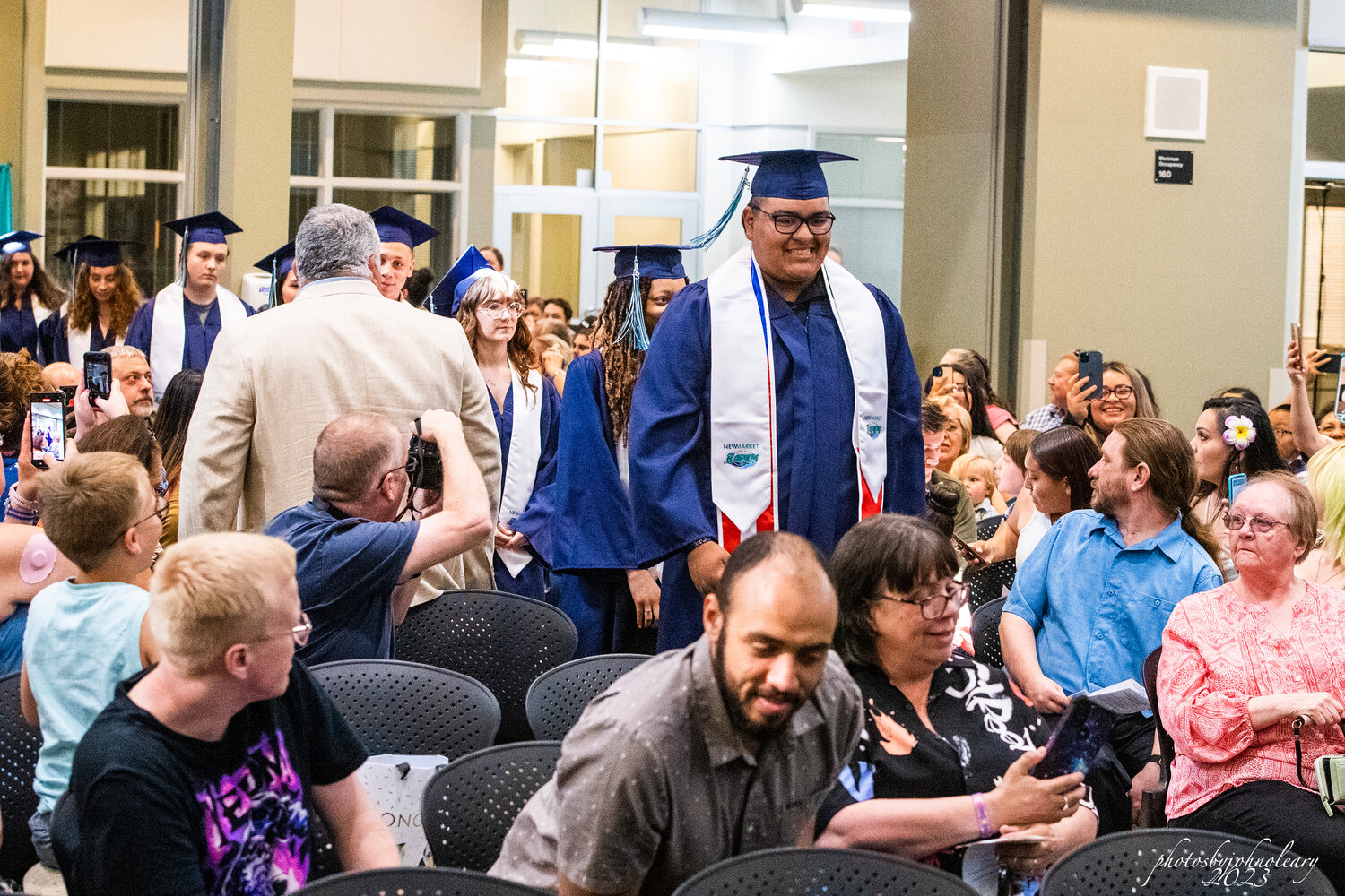 A New Market High School graduate walks the aisle to his diploma.
